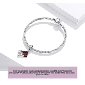 Macro shot of silver mesh bracelet with chocolate charm and Love Forever engraved clasp