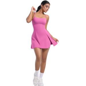 Detail of pink tennis dress featuring slim straps and side slit for active wear