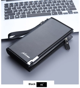 Men's long wallet with zipper closure and wrist strap placed on laptop keyboard