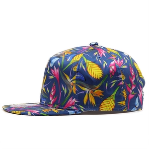 Detail of snapback hat featuring vibrant tropical floral and blue butterfly print patterns