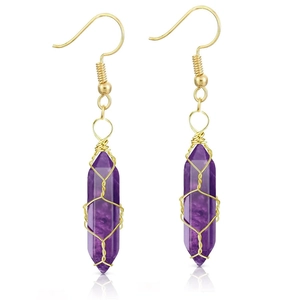 Macro detail of purple quartz earrings with golden wire wrap on a white background