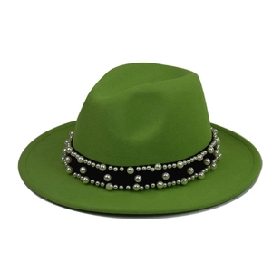 Detail of green wool fedora hat featuring black ribbon band with white pearl embellishments