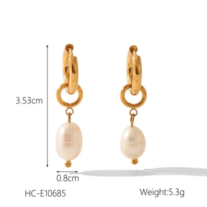 Detailed view of 18k gold plated earrings with white oval pearls and measurement specs
