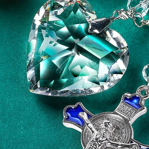 Car mirror pendant featuring a blue crystal heart and St. Benedict enamel cross