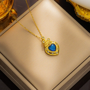 Gold heart castle necklace with blue crystal inlay and zircon details in a gift box