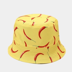 Detailed close-up of yellow bucket hat with red chili pattern and reinforced brim stitching