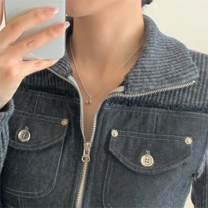 Detailed view of a minimalist 925 sterling silver star pendant necklace on a female model