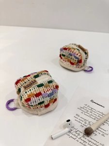 Detail of colorful hand-woven crochet storage pouches for wireless earbuds and small items