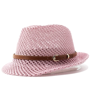 Detail of pink hollow-weave straw fedora with brown faux leather buckle strap
