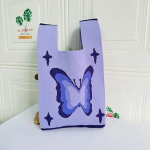 Close-up of butterfly knit tote bag showing thick knit texture and purple blue woven pattern