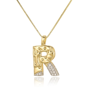 Macro shot of gold letter R pendant with cubic zirconia inlay on a thin box chain