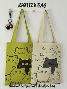 Cute knitted shoulder bag with black cat patterns in green and cream colors for daily use