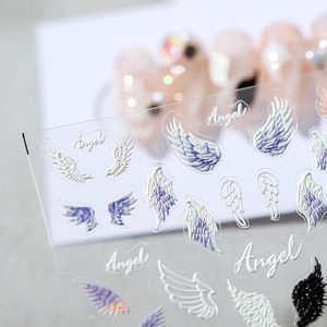 5D embossed nail stickers featuring purple and white angel wing patterns with a textured finish