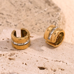 Detail of 18K gold plated ear cuff featuring baguette cut cubic zirconia inlay on stone