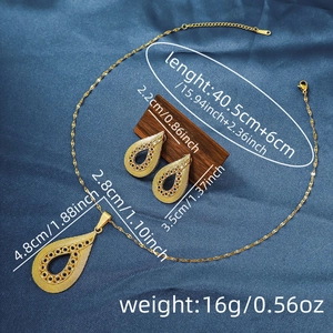 Detailed dimensions of gold vintage teardrop necklace and earrings set on blue fabric