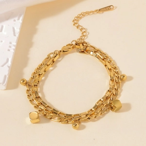 Elegant gold double-layered stainless steel bracelet with geometric charms and extension chain