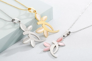 Detail view of leaf pendants with colorful cat eye stones in gold and silver plating