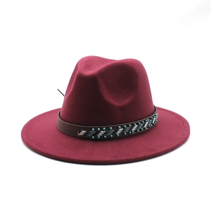 Close-up of wine red wool fedora hat with ethnic beaded leather band and wide brim