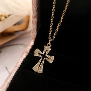 Close-up of 18K gold plated cross necklace featuring micro-set zircons and black enamel
