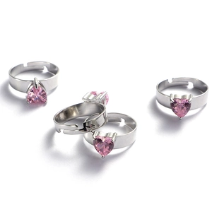Detailed close-up of pink heart-shaped crystal rings with silver adjustable bands