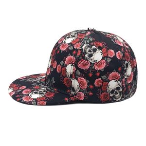 Detail of flat brim snapback featuring realistic skull and red rose gothic print