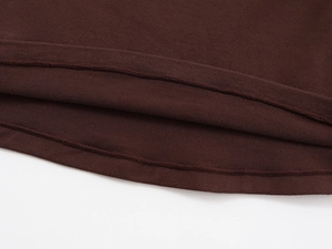 Macro view of double-needle stitching and fabric texture on a brown knit cotton T-shirt
