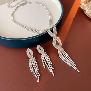 Detailed close-up of a luxury silver tassel necklace and earring set with crystals