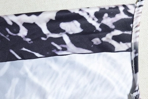 Detailed close-up of snake print fabric with refined stitching on a bodycon midi dress