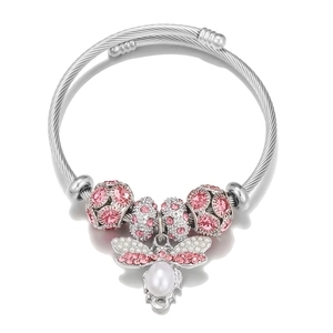 Detail of beaded steel wire bracelet featuring pink rhinestones and pearl insect charm
