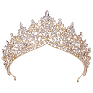 Close-up of gold bridal crown featuring intricate crystal rhinestones on a white background