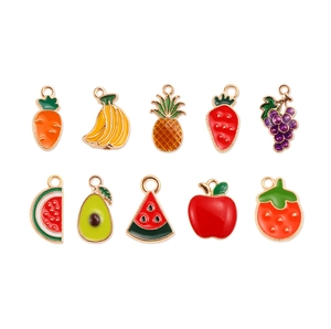 Detail of ten assorted colorful enamel fruit charms for DIY jewelry making on white background