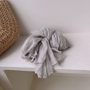 Detail showing the pleated texture and grey gradient of a vintage lightweight silk scarf