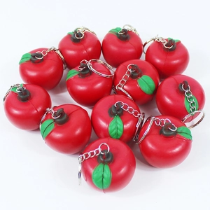 Set of cute mini red apple squishy keychains with green leaves on white background