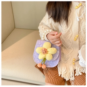 Detail of purple fabric mini bag with large yellow flower and elegant pearl handle strap