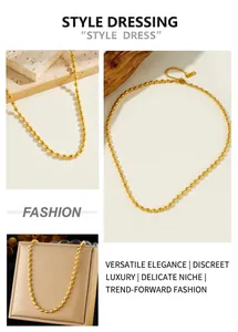 Detailed view of a gold football chain necklace with lobster clasp and extension link