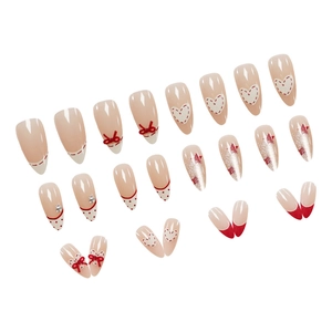 Red bow almond fake nails with polka dots, glitter stars and heart nail art designs