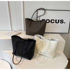 Three woven tote bags in black, brown, and cream white on a clean white background