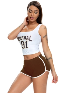 Side view detail of a white cropped tank top and brown elastic yoga sports shorts