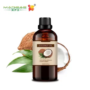 Organic coconut oil 100ml in dark glass bottle with fresh coconut and green leaves