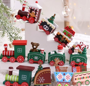 Detail of wooden Christmas train toy with gingerbread man and snowman on white stand