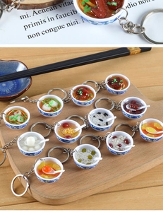 Detailed set of 12 miniature blue and white porcelain bowl food keychains on wood