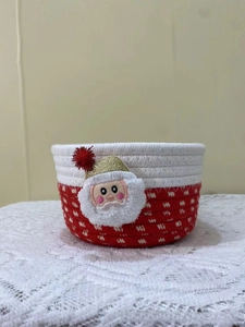 Detail of red and white woven cotton Christmas basket with Santa Claus embroidery patch
