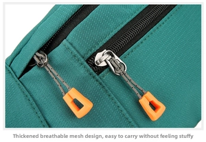 Detail of durable teal oxford cloth waist bag with orange pullers and double zippers