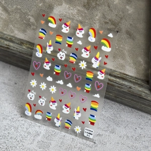 Simpatici adesivi per unghie con unicorno e arcobaleno per bambini su sfondo grigio