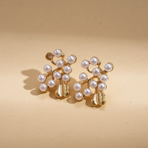 Detailed macro shot of vintage gold flower pearl earrings with textured metal drops