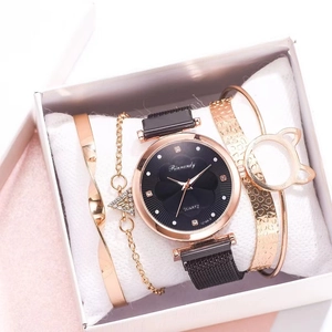 Close-up of a 4-piece jewelry gift set with a gold quartz watch and three bracelets