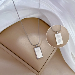 Detailed view of silver brick pendant necklace with GOLD and Chinese character engraving