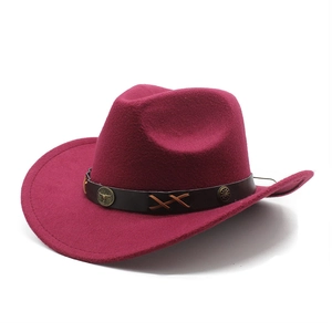Detail of burgundy wool felt cowboy hat with leather band and vintage metal accents
