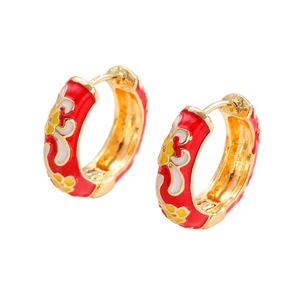 Detail of red enamel flower earrings with gold finish and traditional Chinese patterns