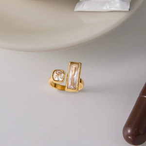 Macro detail of a gold stainless steel ring with square and rectangular crystals
